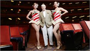 Don Hewitt with two Rockettes.